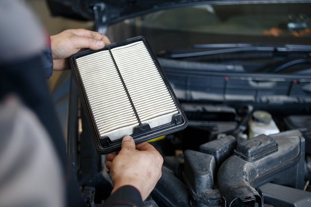 Service technician holding engine air filter