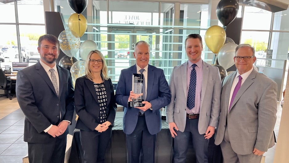 Team members with the Buick Dealer of the Year award